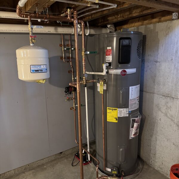 Rheem hybrid heat pump water heater installed with new copper piping and an expansion tank